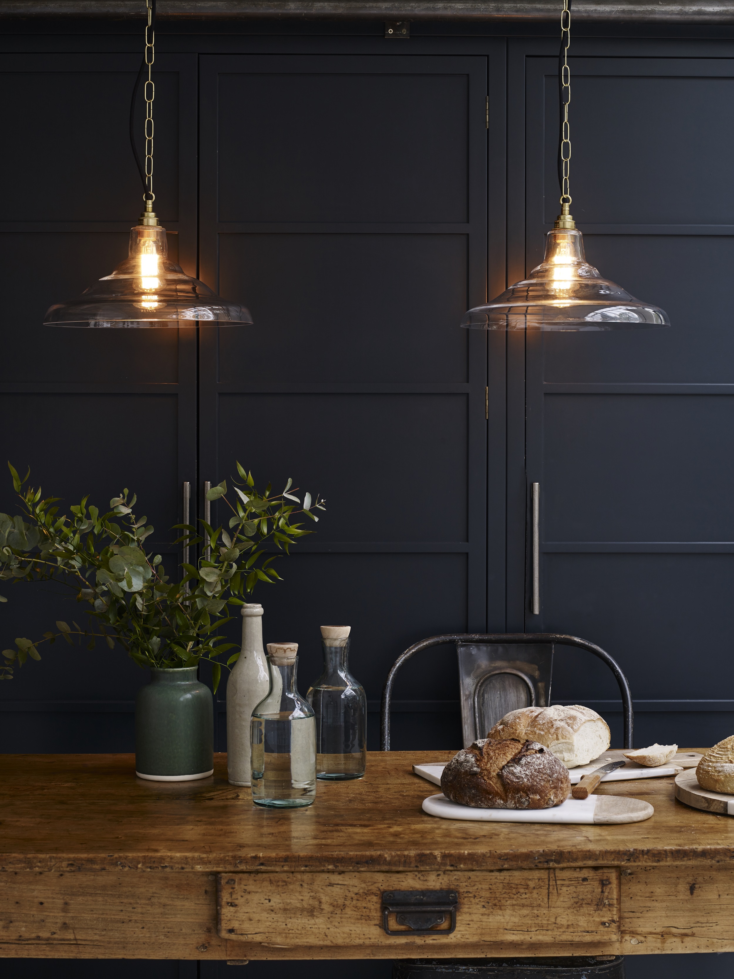 Warm low lighting in a dark decorated kitchen