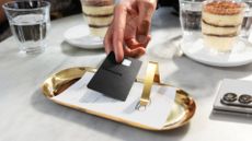 Samsung Galaxy Credit Card being used to pay a bill at a restaurant