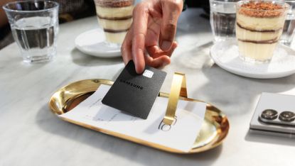 Samsung Galaxy Credit Card being used to pay a bill at a restaurant
