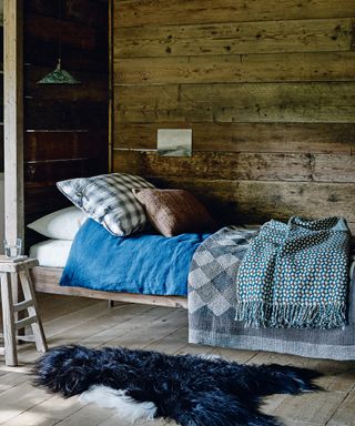 Reclaimed wooden room with blue bedding