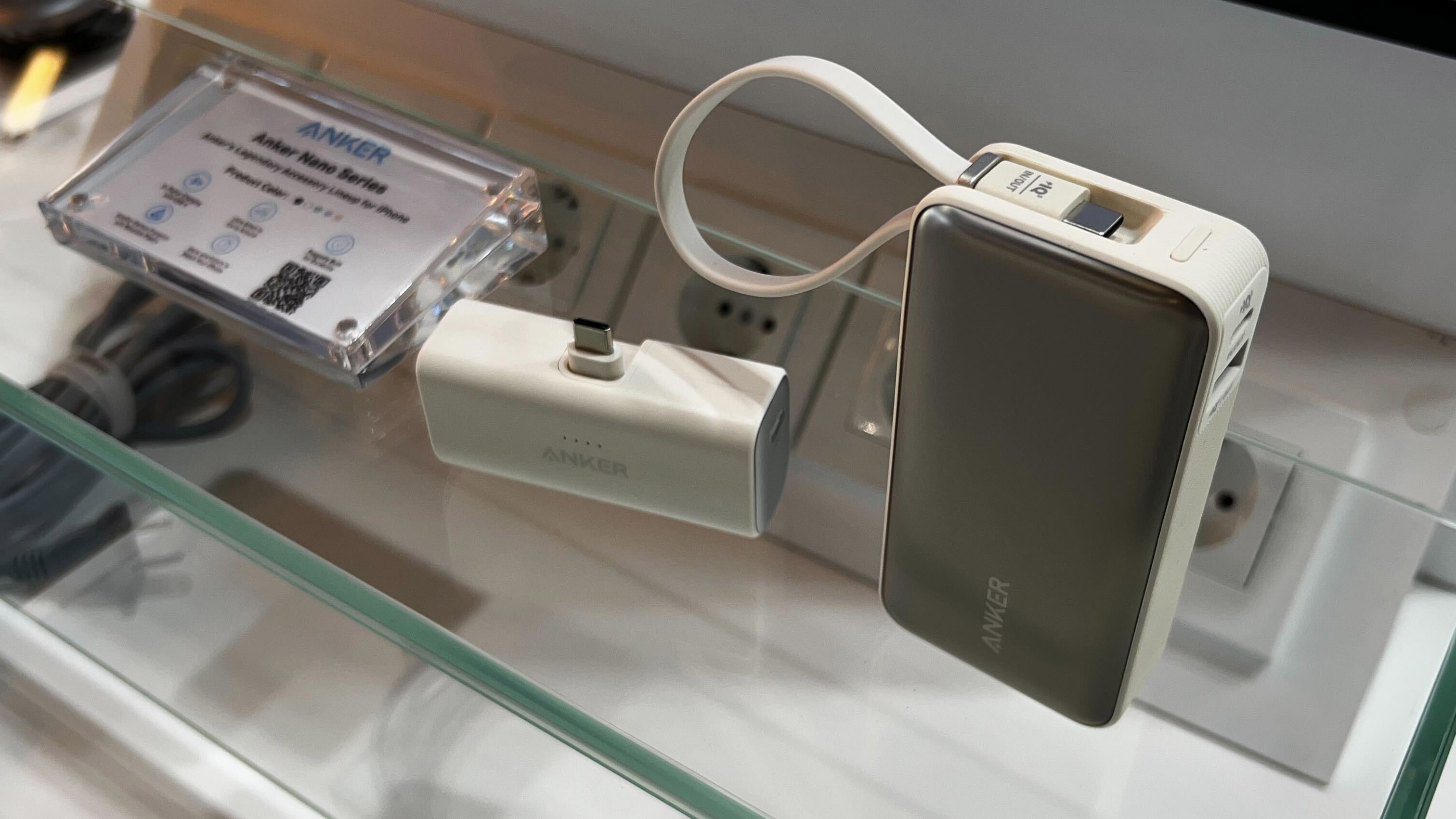 An Anker MagGo charger sitting on a glass table