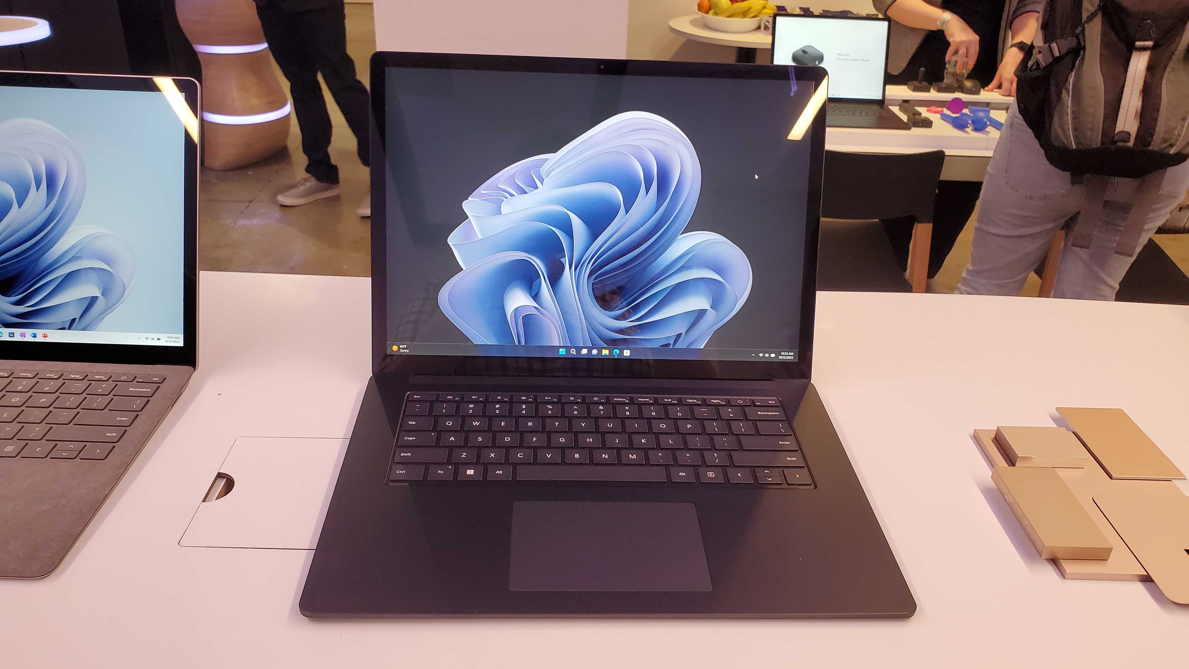 black laptop sitting on wooden desk