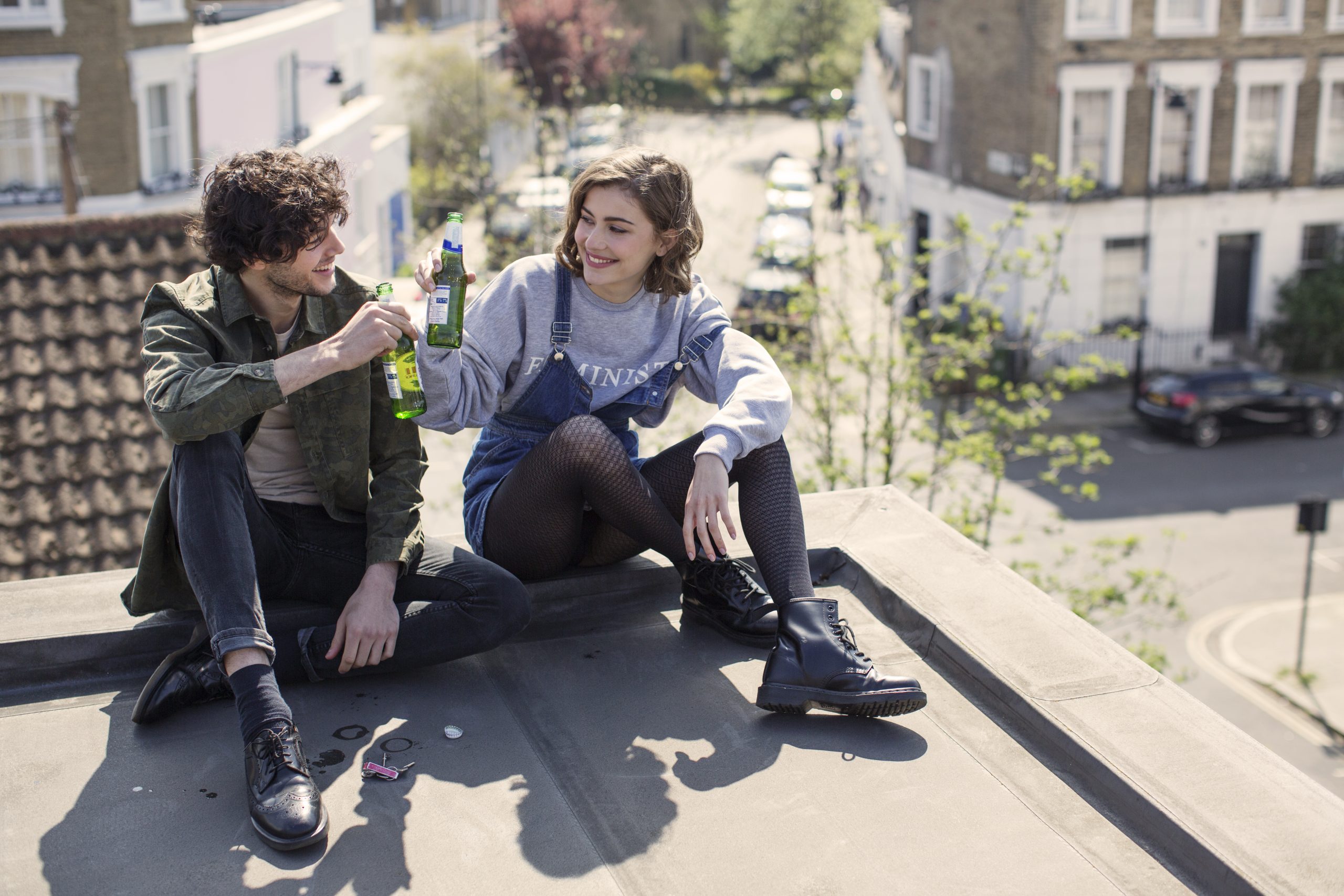 Man and woman having beers on the roof after Covid vaccine