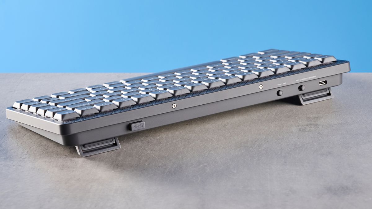 The NuPhy Node75 on a stone surface with a blue background