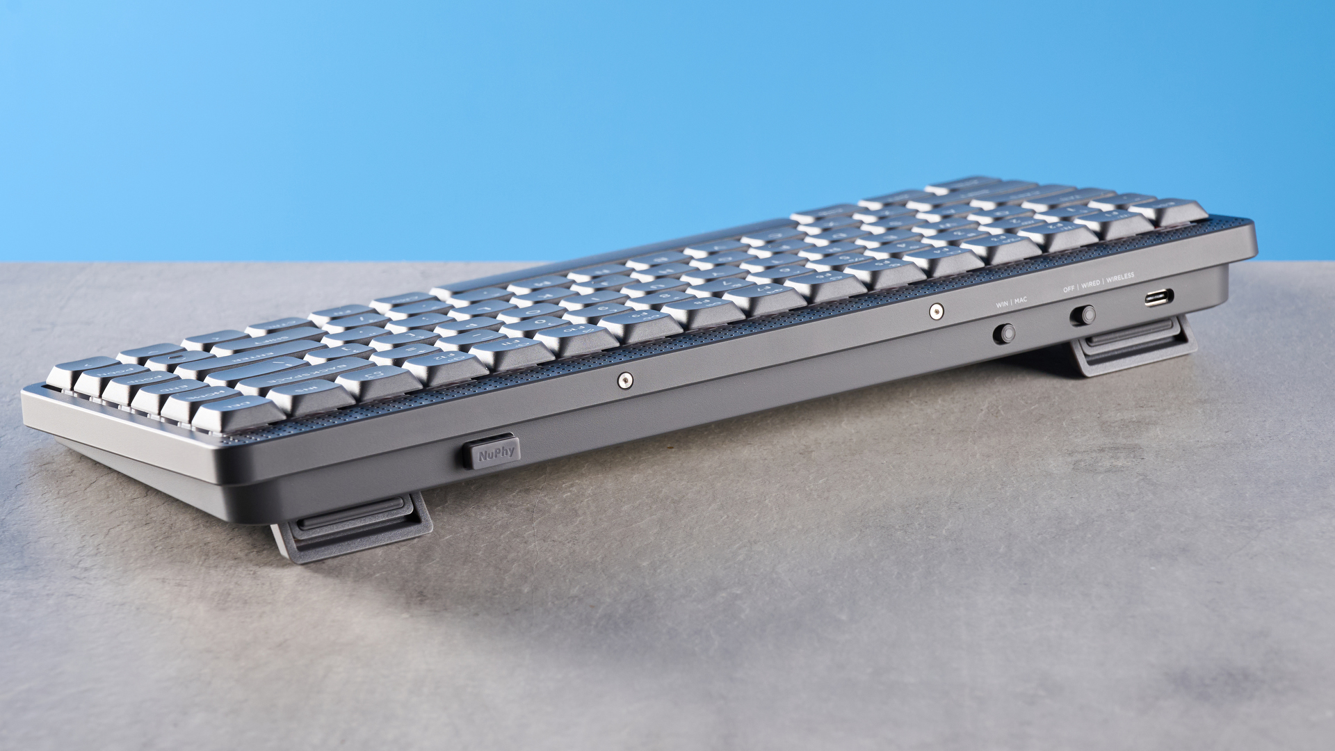 The NuPhy Node75 on a stone surface with a blue background