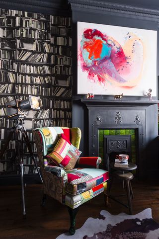 black living room with full book shelves