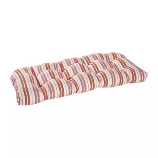 A pink and red striped cushion