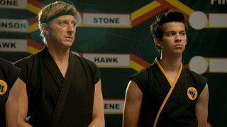 Johnny Lawrence (William Zabka) and Miguel Diaz (Xolo Maridueña) watch on in a competition.