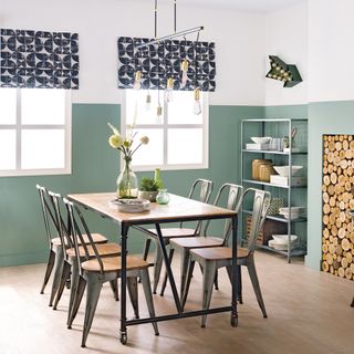 green dining room with dining table chairs and patterned blinds