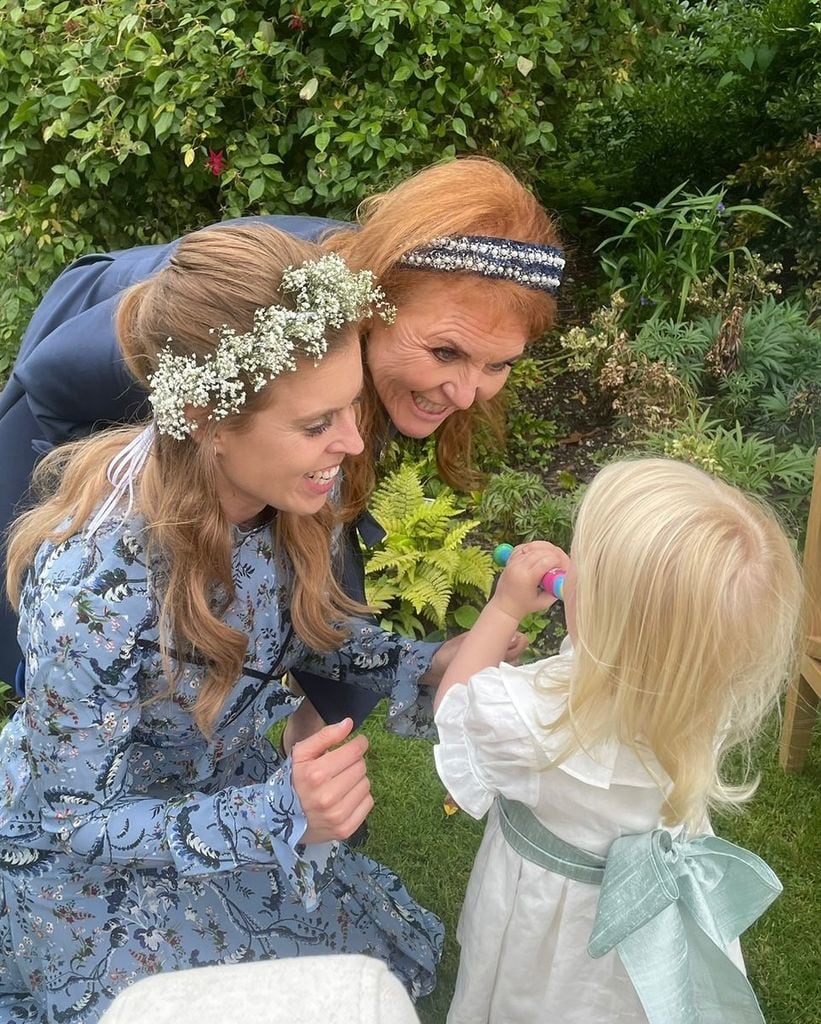 Sarah Ferguson and Princess Beatrice bending down and smiling at Sienna Mapelli Mozzi