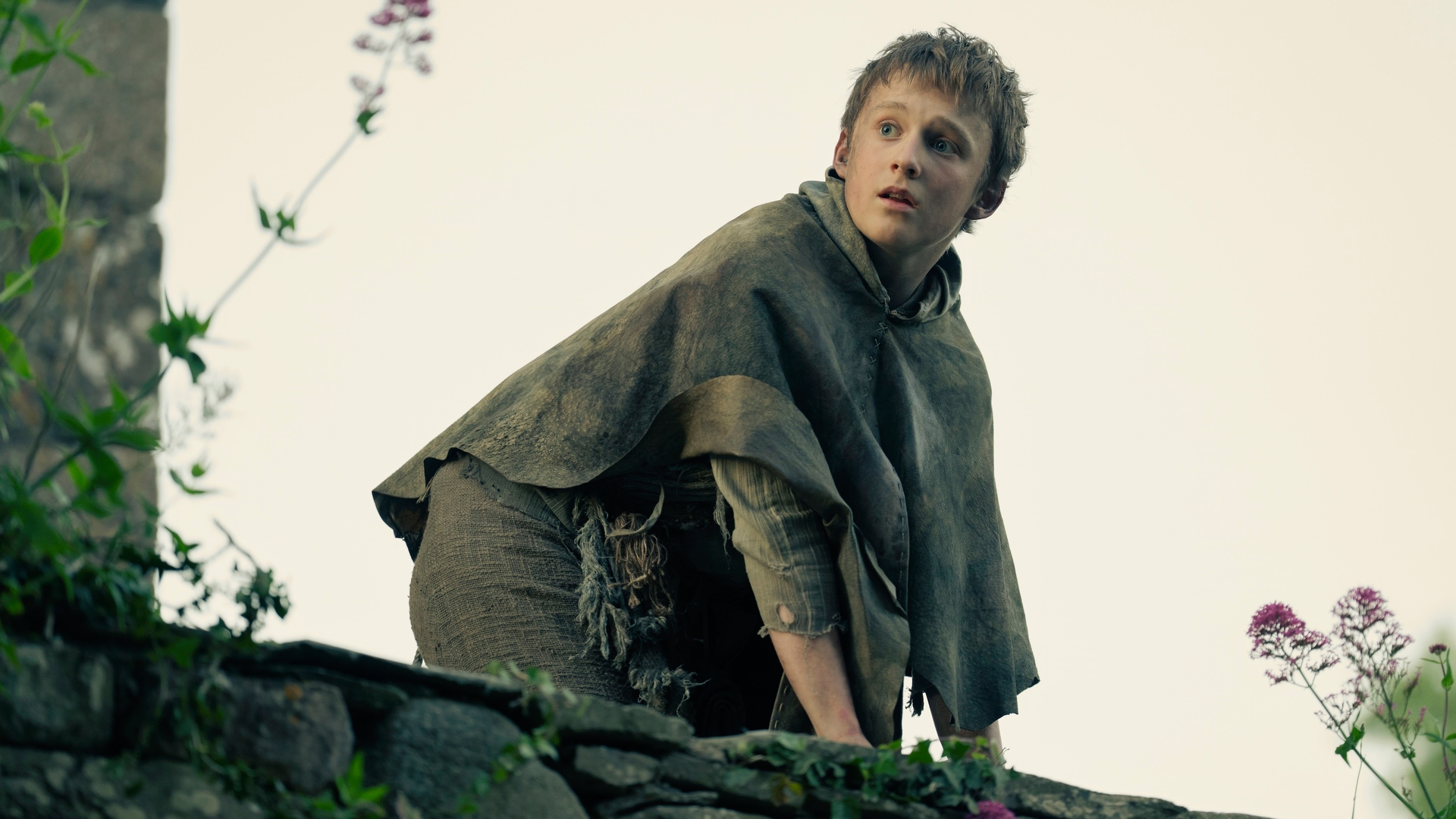 Young Dunk (Bamber Todd) crouches on a wall in a scene from "A Knight of the Seven Kingdoms" episode 5