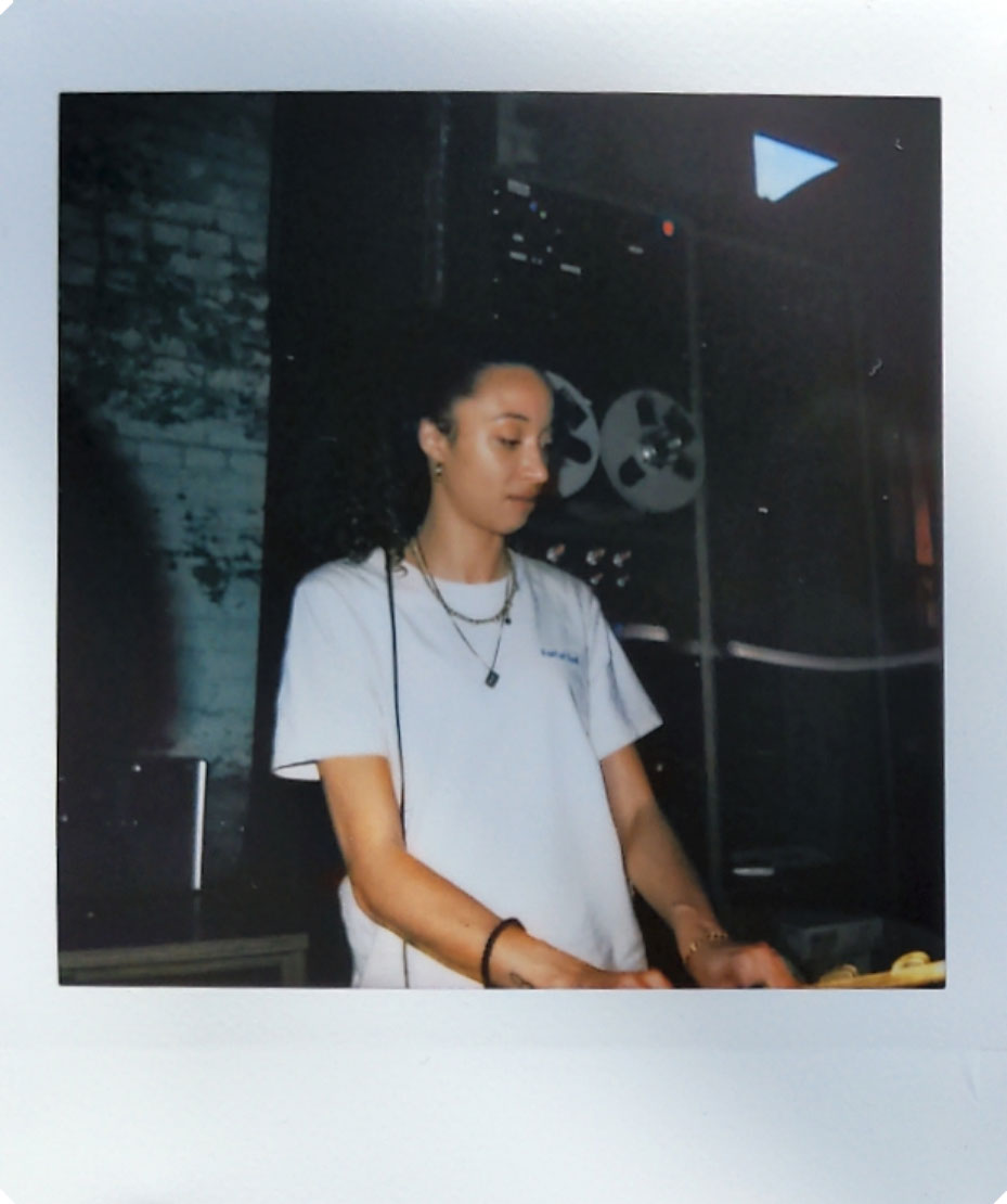 Digitized instant photo taken with the Fujifilm Instax SQ40 of DJ indoors in darkly lit bar