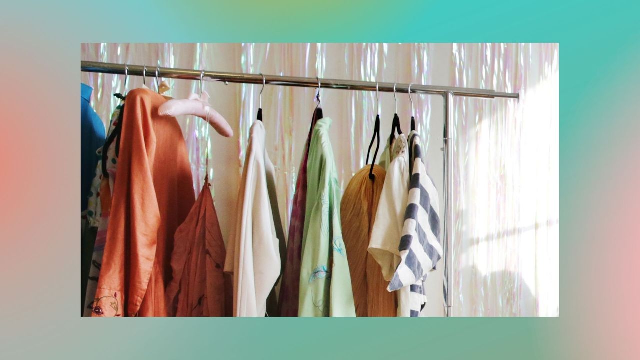 A railing of colorful clothes on hangers 