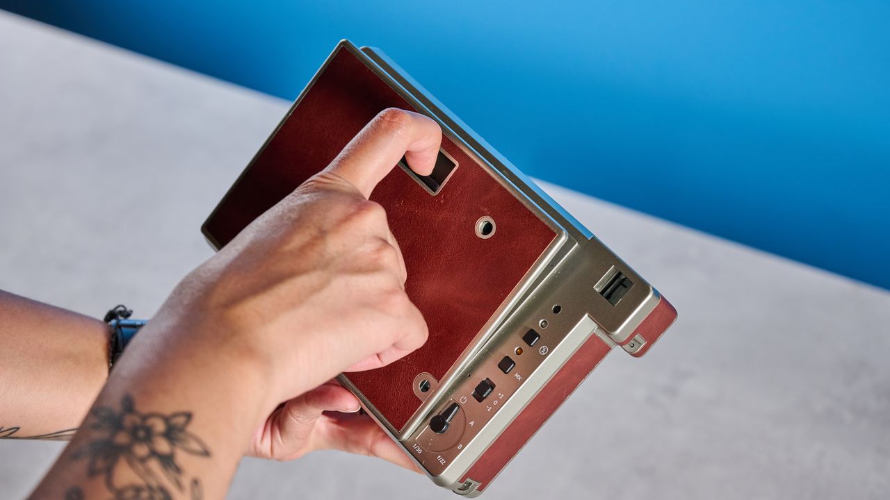 A brown Lomography Lomo'Instant Wide Glass instant camera
