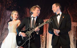 Taylor Swift, Jon Bon Jovi and Prince William, Duke of Cambridge sing on stage at the Centrepoint Gala Dinner at Kensington Palace