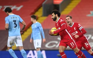 Mohamed Salah celebrates with Jordan Henderson after scoring against Manchester City