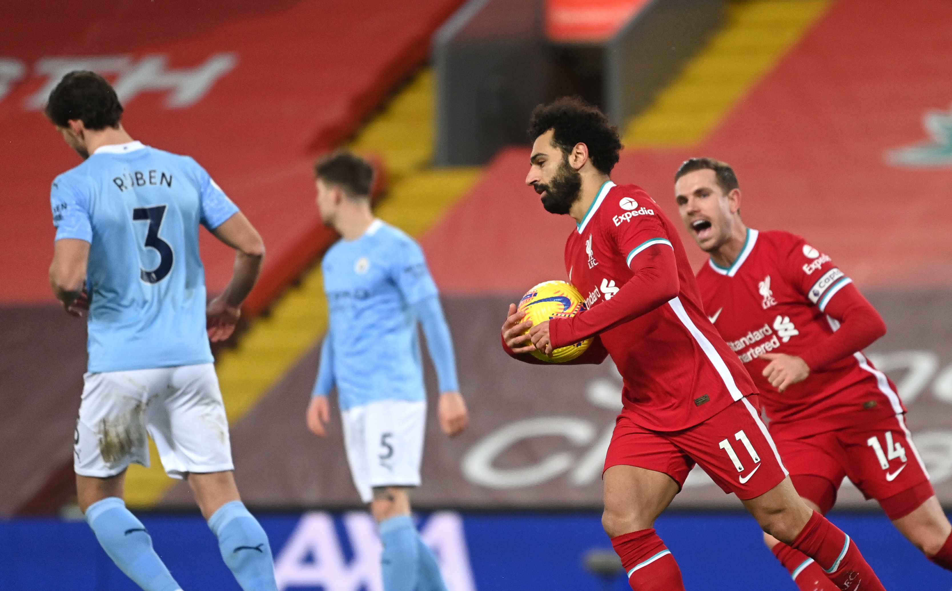 Mohamed Salah celebrates with Jordan Henderson after scoring against Manchester City