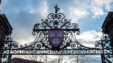 Harvard University's 'Veritas' shield on a pair of gates