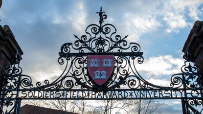 Harvard University's 'Veritas' shield on a pair of gates