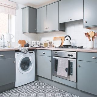 gas hob in grey kitchen with patterned floor tiles