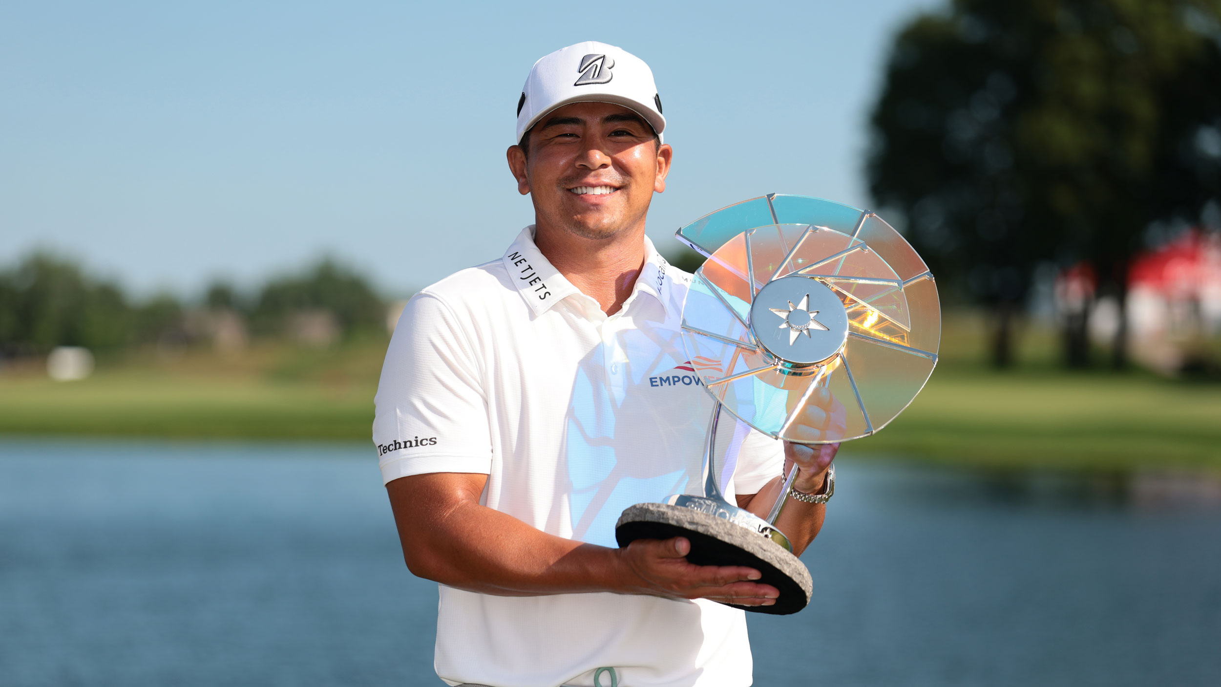 Kurt Kitayama poses with the 3M Open trophy after winning in 2025
