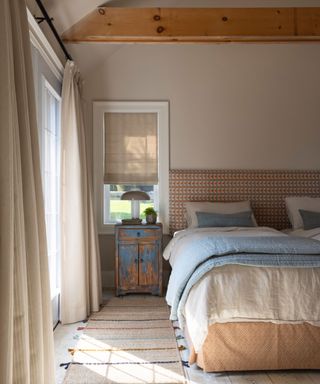 calming bedroom with neutral color scheme and light blue throw and cushions