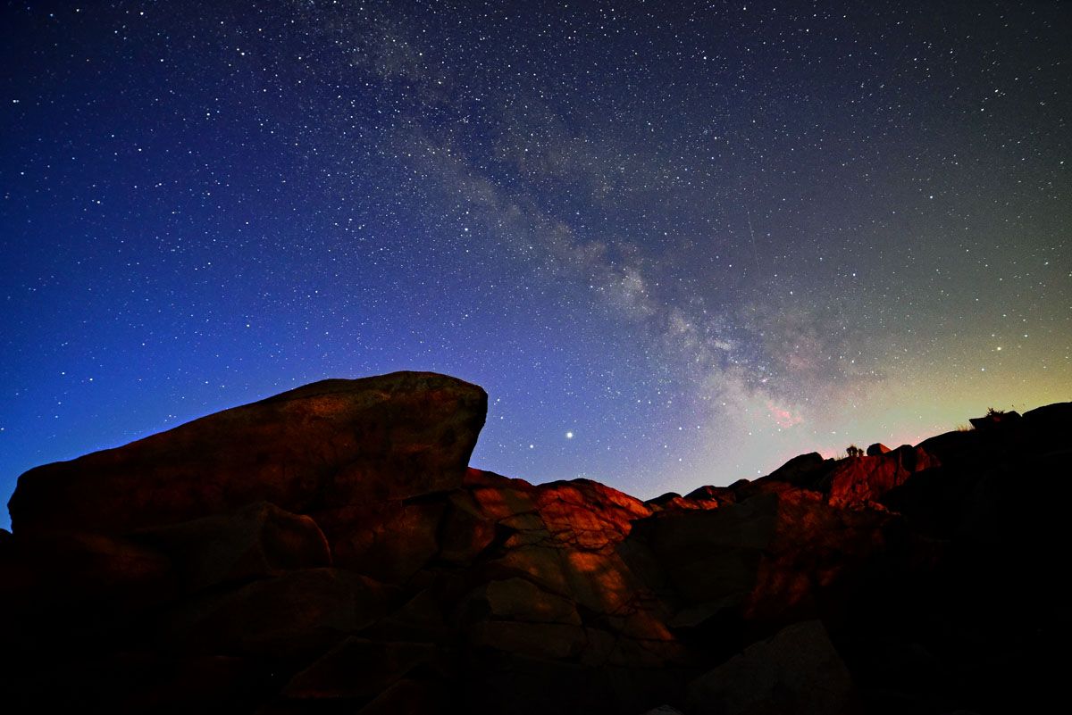 A faint Lyrid meteor is barely visible to the right of the Milky Way galaxy shortly before dawn on April 22, 2020, in this photo captured by Andrew March in Rockport, Massachusetts.