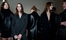 Models wearing black leather jackets with fur and gray and black striped suits, from the Costume National A/W 2015 collection.