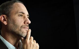 thoughtful man on a black background.