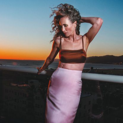 andie macdowell standing against a sunset