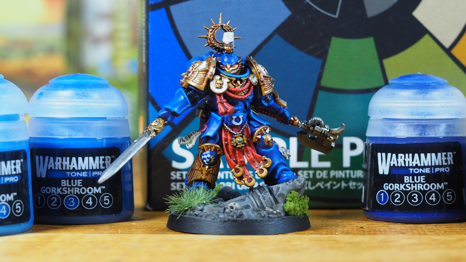Kaius Konorious miniature painted using Warhammer Tone Pro, surrounded by paint pots