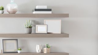 Three floating shelves in a bedroom