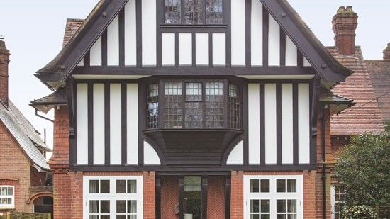 brick wall house with brown window and roof top