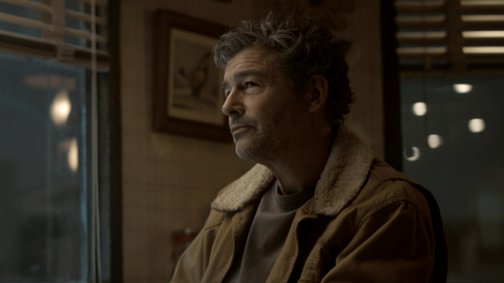 Kyle Chandler, in a brown jacket with fur collar, as Hal Jordan in the sixth episode "Bad Optics" of Lanterns (2026).