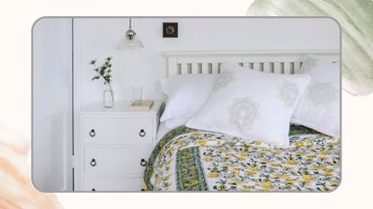 A white bedroom with a white wooden bed frame and green eiderdown on the bed