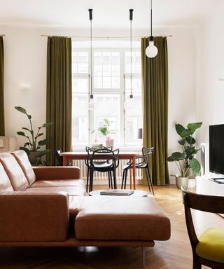 Organic modern living room with a brown sofa and earthy green curtains