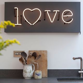 kitchen area with love wall art and kitchne sink