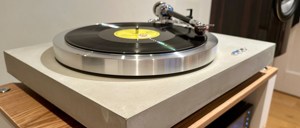 The EAT C-Dur Concrete turntable on a wooden shelf