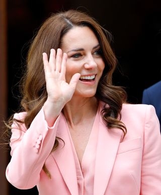Kate Middleton waving in a pink suit