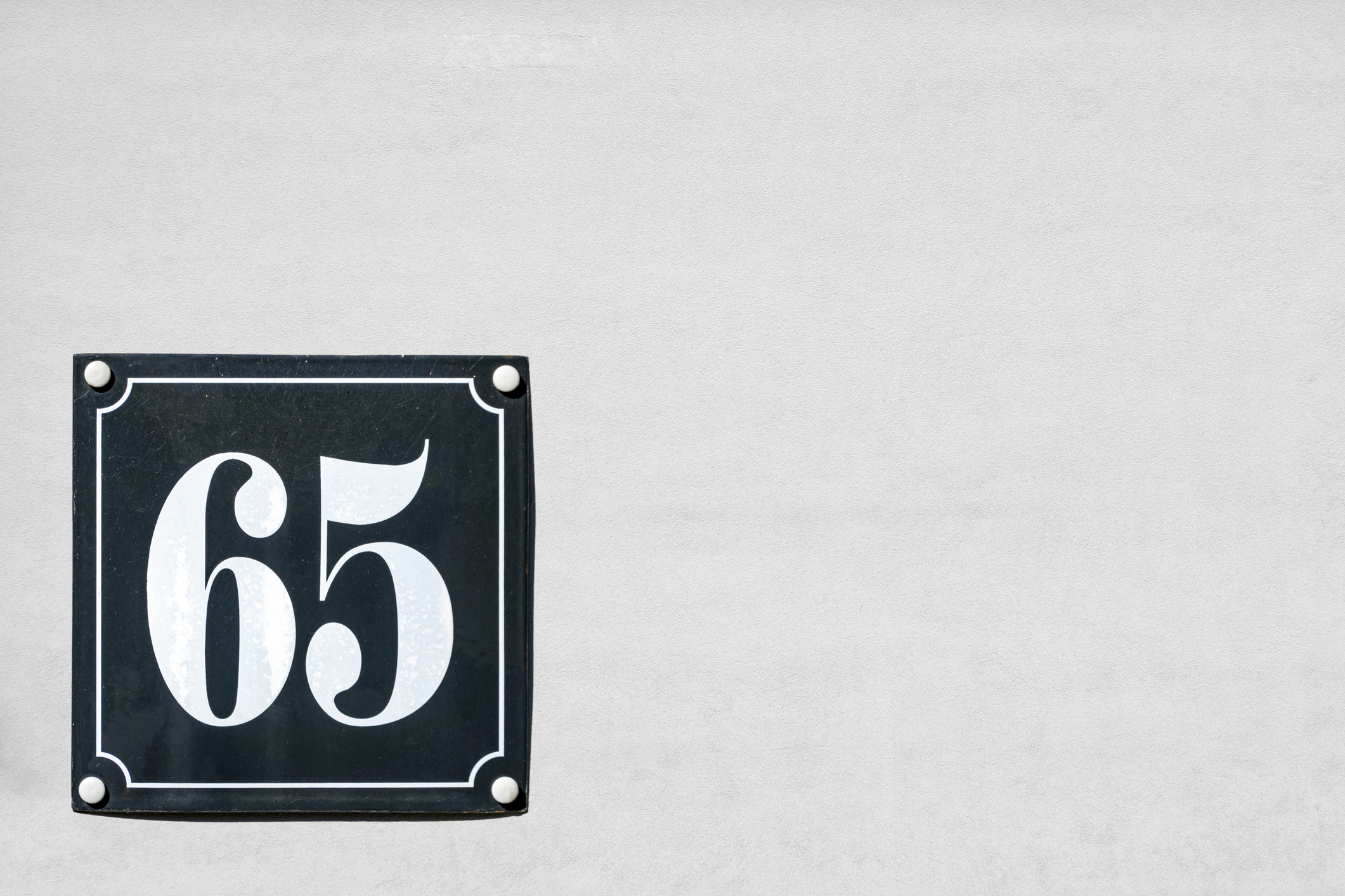 the number 65 on a black tile 