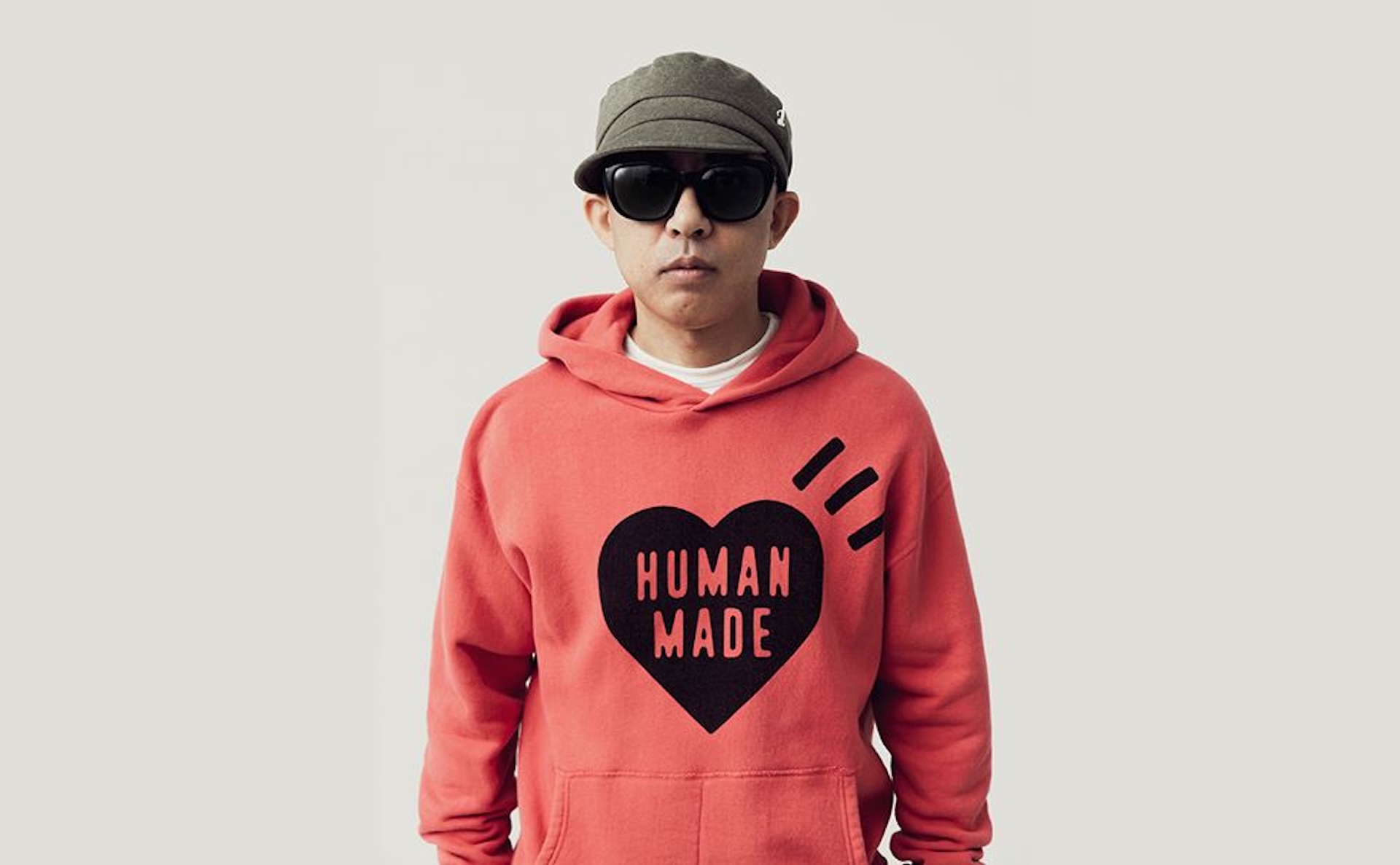 NIGO wearing a Human Made hoodie, sunglasses and a hat