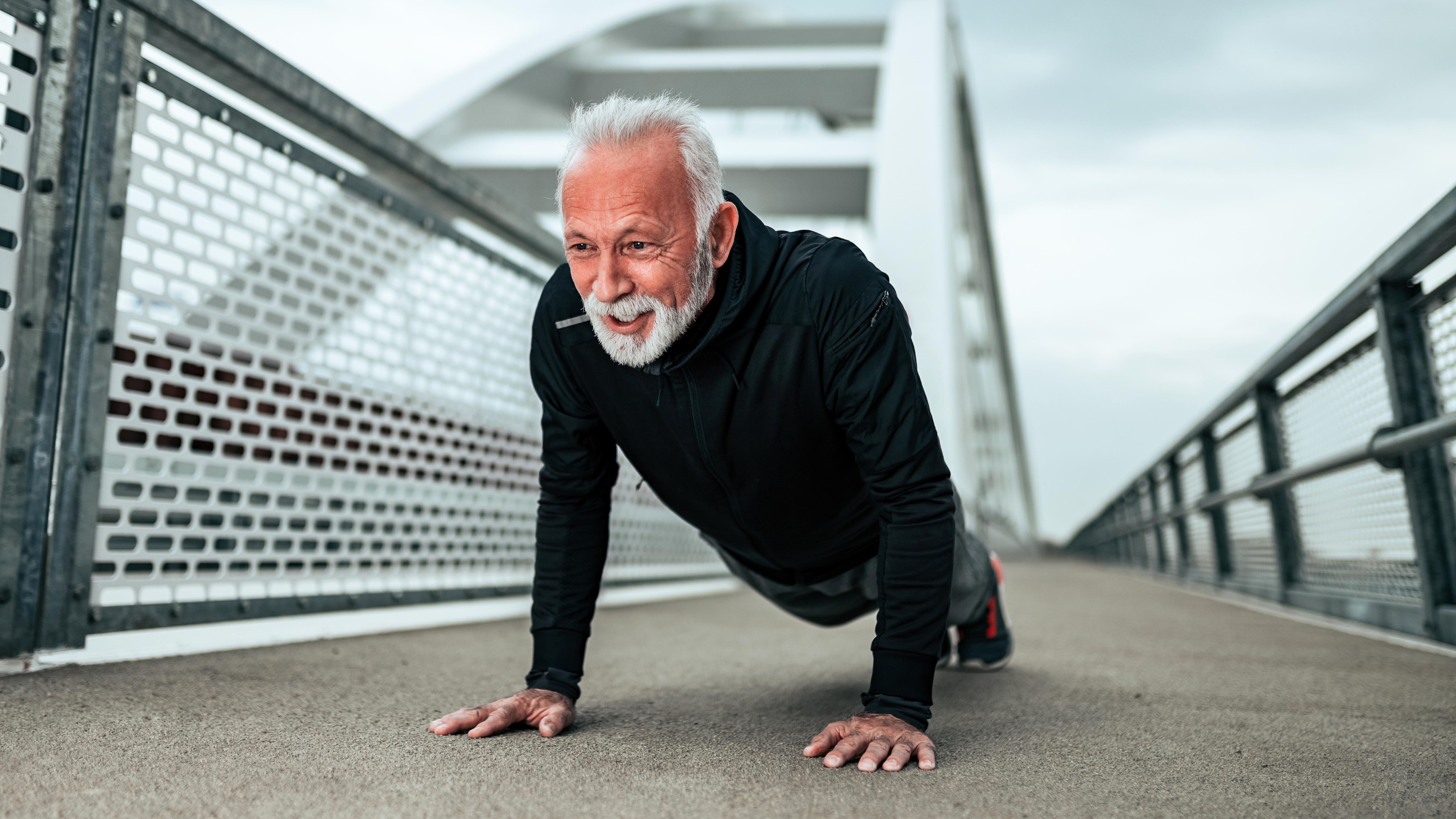 a senior man doing a push up