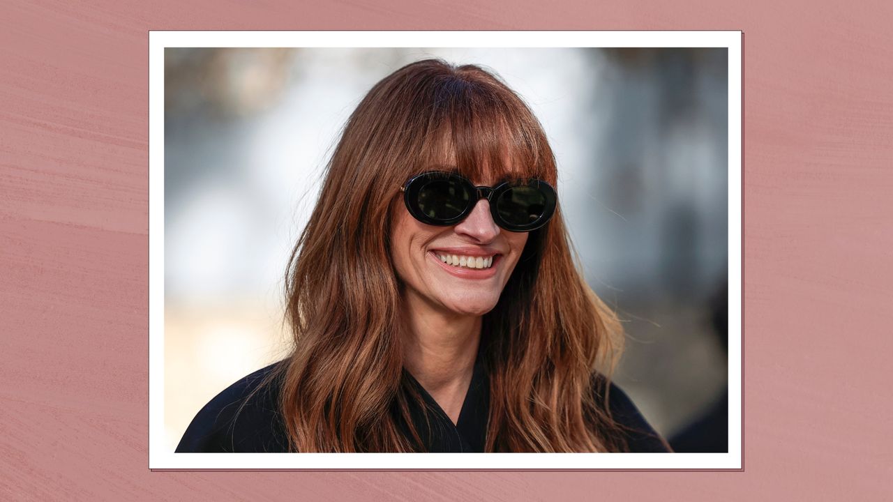 Julia Roberts is pictured with dark copper hair whilst arriving for the Jacquemus Womenswear Ready-to-wear Spring-Summer 2024 collection at Maeght Foundation, in Saint-Paul-de-Vence, southern France, on January 29, 2024/ in a dark pink template