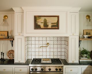 White kitchen backsplash ideas in a white farmhouse-style kitchen with a terracotta tiled backsplash behind the oven.