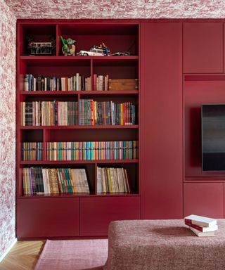 gloss red media unit shelving with wallpapered walls and ceiling