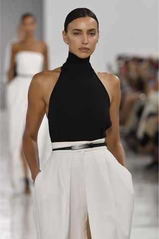 Irina Shayk at Max Mara wearing slicked bun, a key Spring/Summer 2025 fashion month beauty look