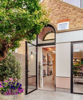 Modern rear extension East London house with arch window arch door
