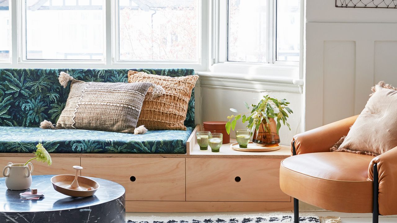 Living room with built-in seating under sofa in bay window area