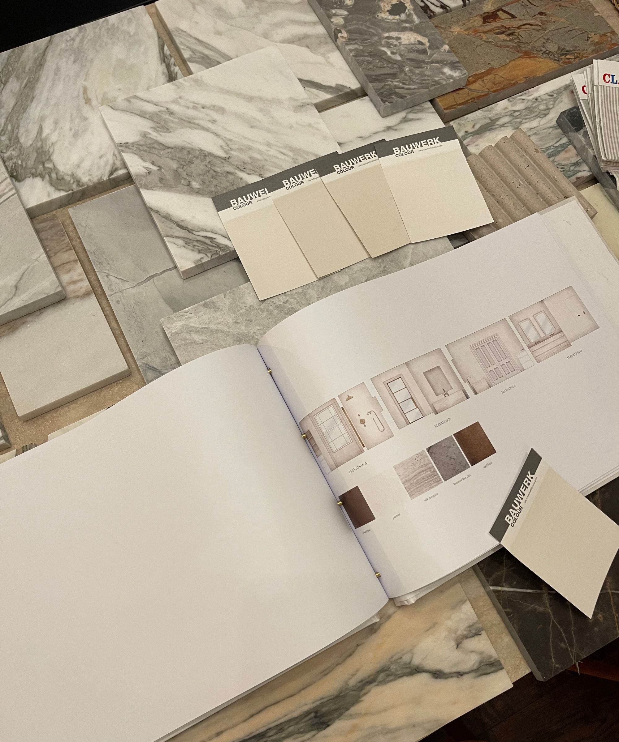 Close up of room sketches and fabric samples on table