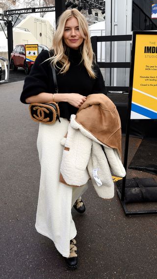 Sienna Miller wearing borg-lined combat boots and a fluffy Chanel crossbody bag